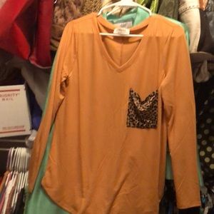 This is a spandex shirt it’s  soft and it’s like a peachy color